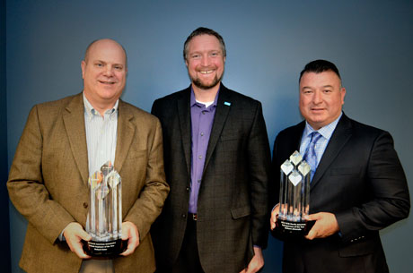 Richard Oster (left) receives his Employee of the Year award and Robert Alvarado (right) receives his Salesperson of the Year award from Paul Whittleston, BASF Vice President, Automotive Refinish, North America.