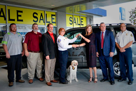 Fire Investigator Roseanne Moreland and K9 Gracie of the Ocala Fire Department in Florida receives keys to a Recycled Rides from State Farm and Jenkins Collision Center in Ocala.