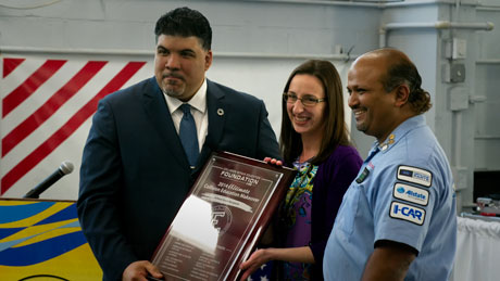 Ojeda and Roopnarine accept a plaque commemorating their 2014 Makeover Grant from Melissa Marscin (center) director of grant programs for the Collision Repair Education Foundation.