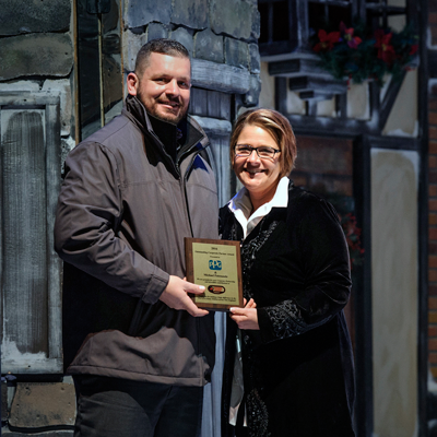 Michael Patenaude (left), PPG regional sales manager, automotive refinish, accepts the "Sponsor of the Year" award from Speedway Children’s Charities New Hampshire Chapter Director Cheryl LaPrade. 