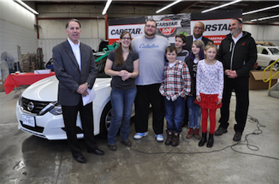 Dean Fisher (left), COO of CARSTAR North, Theresa Workman, husband Dustin, and children Nickolas, Ethan, Caitlyn and Mercedes, with Kevin Norman of Nationwide Insurance and Keven Raines, owner of CARSTAR West Chester.